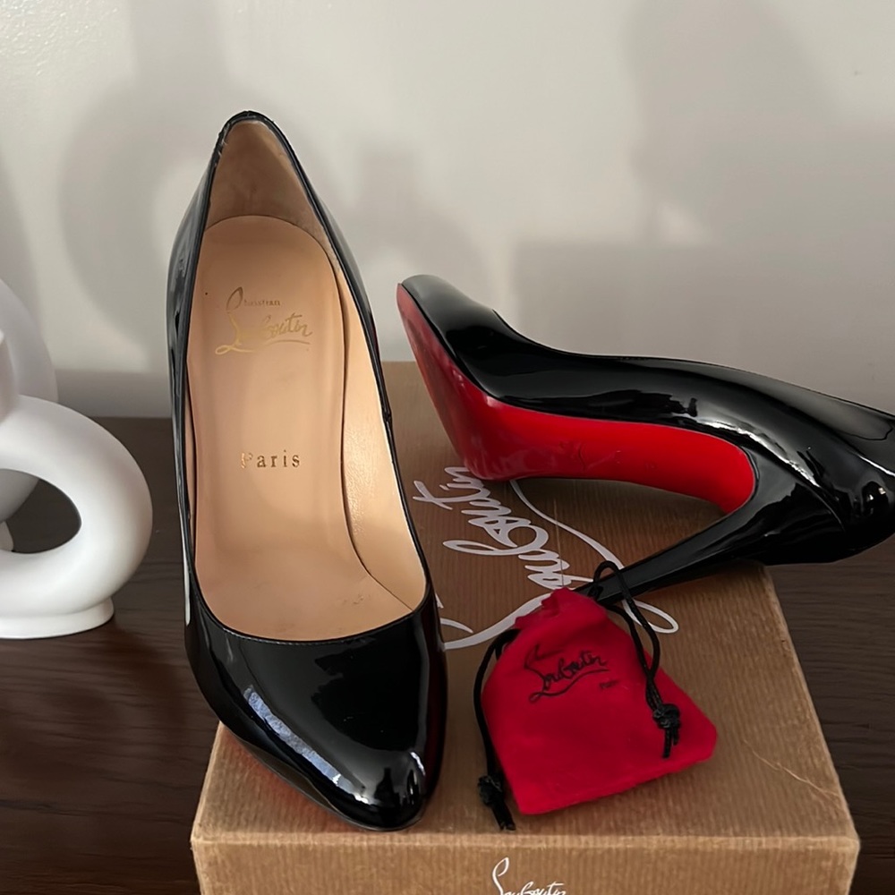 Authentic Christian Louboutin Black patent pumps.